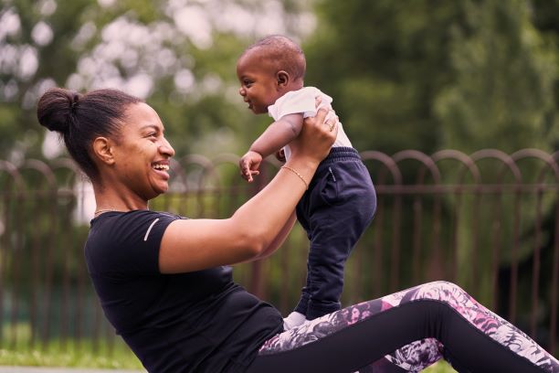 Woman and baby sit up